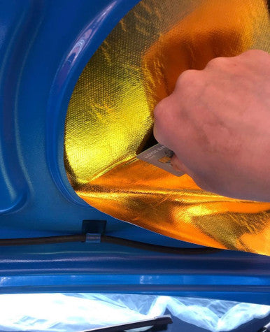 Cutting adhesive heat reflective sheet to shape
