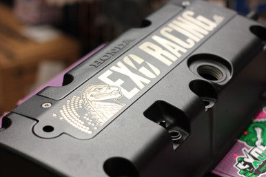 Close up of engraved Exoracing logo on black aluminium K20 K24 plug cover