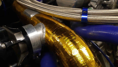 Reflective heat sheet protecting panel near turbo heat