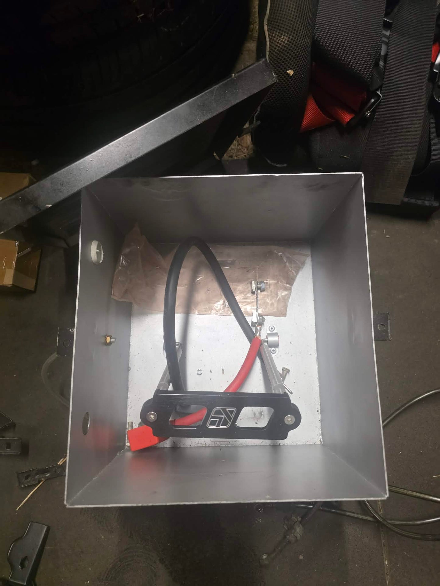 Battery box with battery tie down and cables