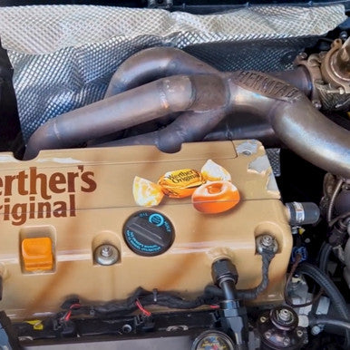 Exoracing embossed heat shield fitted near exhaust manifold
